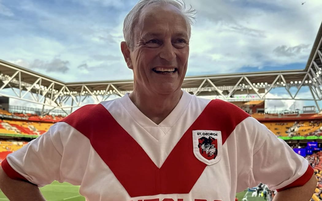RNZ executive editor Jeremy Rees proudly sports his retro St George Dragons jersey at the 2026 NRL Magic Round at Suncorp Stadium in Brisbane.