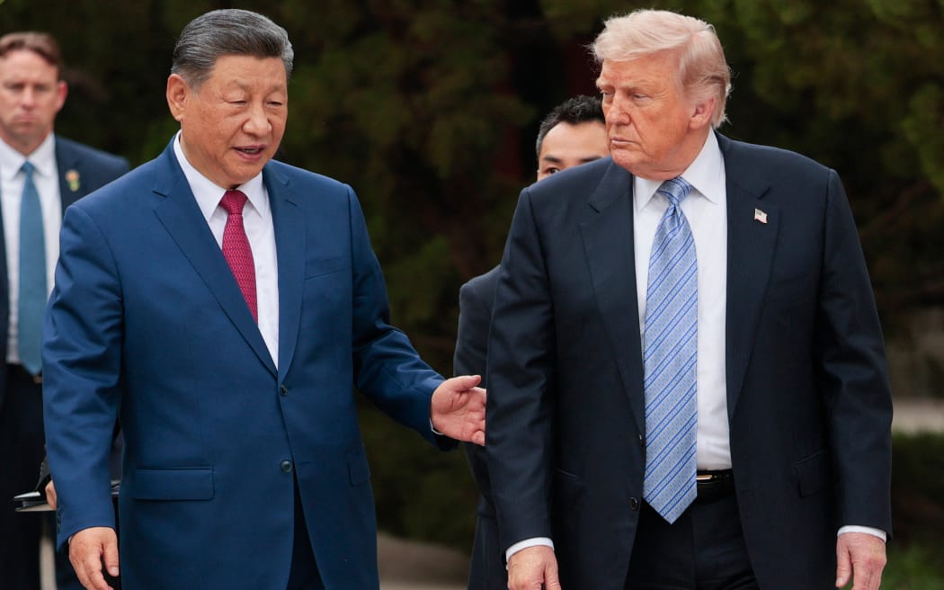 US President Donald Trump (R) walks with China’s President Xi Jinping (L) as he leaves after a visit to Zhongnanhai Garden in Beijing on May 15, 2026. (Photo by Evan Vucci / POOL / AFP)