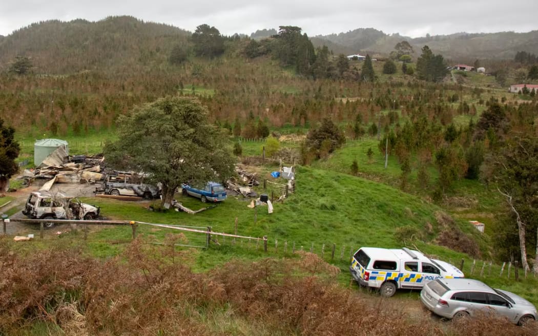 The aftermath of the fire at Sidney Ross Bridson's home on Waitaanga Rd. The home of his neighbour, Mathew David Hannon, is the building pictured on the left in the background.