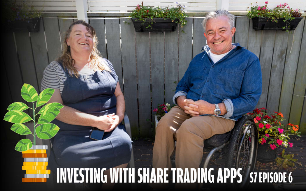 Two people sit outdoors in front of a wooden fence with flower boxes, laughing together in the sunshine. The woman on the left wears a denim pinafore over a striped top, and the man on the right, who uses a wheelchair, is dressed in a blue denim shirt. The show's illustrated logo appears in the bottom left. Bold white text reads "Investing with Share Trading Apps — S7 Episode 6."