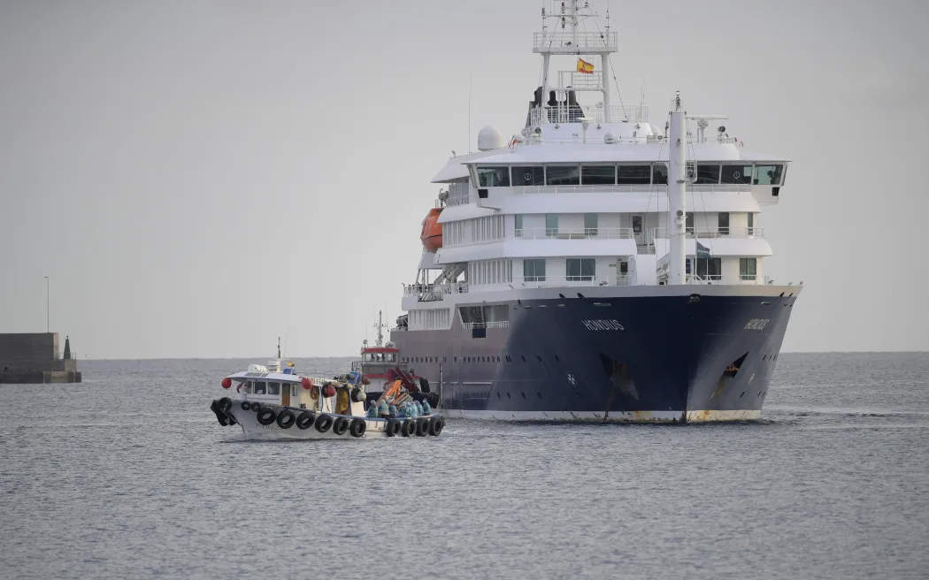US passengers from the Dutch flagged hantavirus-stricken cruise ship MV Hondius are transferred by boat to the industrial port of Granadilla de Abona on the island of Tenerife in Spain's Canary Islands on May 10, 2026. Repatriation flights for the nearly 150 passengers onboard the ship hit by a deadly hantavirus outbreak got underway as passengers and some crew members were transferred to shore on smaller vessels then by bus to the airport and then flown home after weeks at sea.