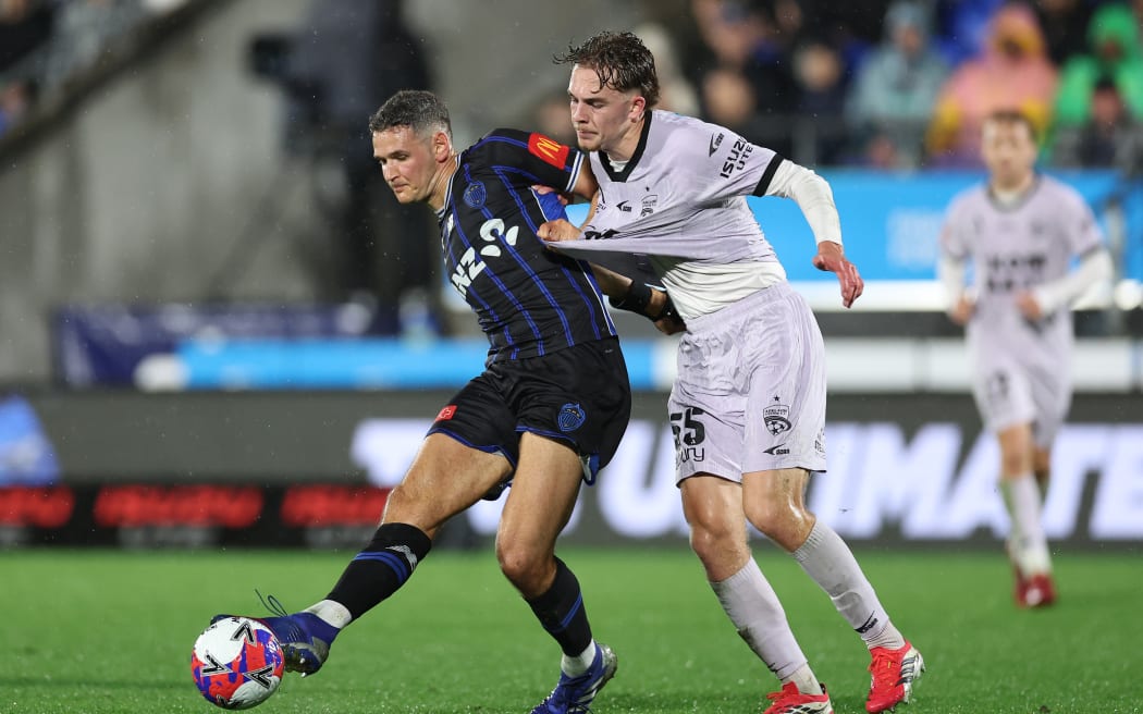 Louis Verstraete, left, of Auckland FC, kicks the ball under the challenge of Ethan Alagich in the A-League first semifinal leg at Mount Smart Stadium, 9 May, 2026.
Photo: Fiona Goodall / Photosport