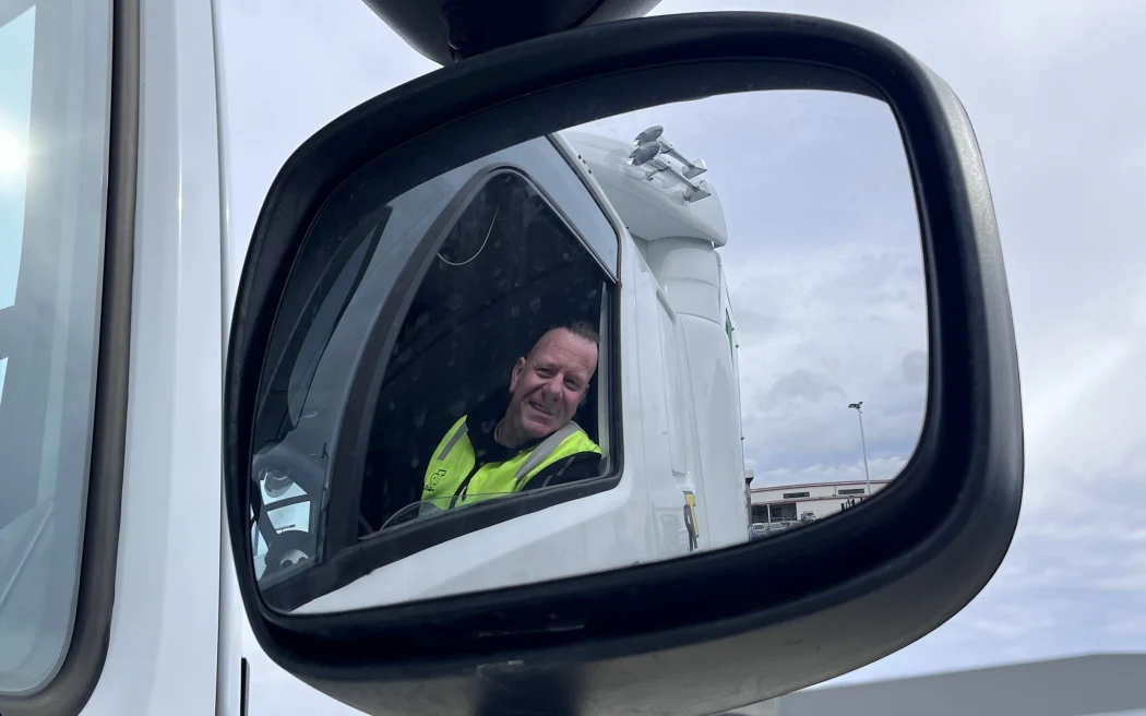 TR Group driver trainer Paul Fair shown reflected in the wing mirror of a truck.