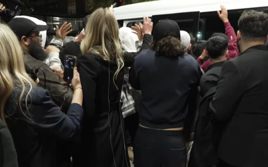 The group made a chaotic exit from Melbourne Airport towards a waiting vehicle, tailed by media.