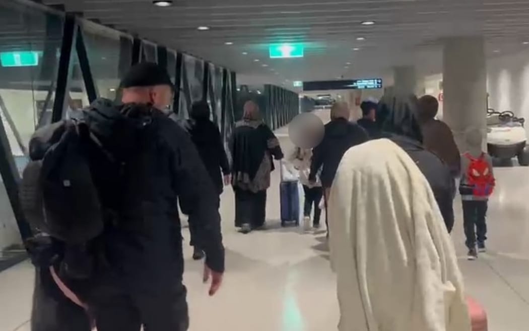 Women who left the Al Roj camp in Syria walking through Melbourne Airport after landing in Australia.