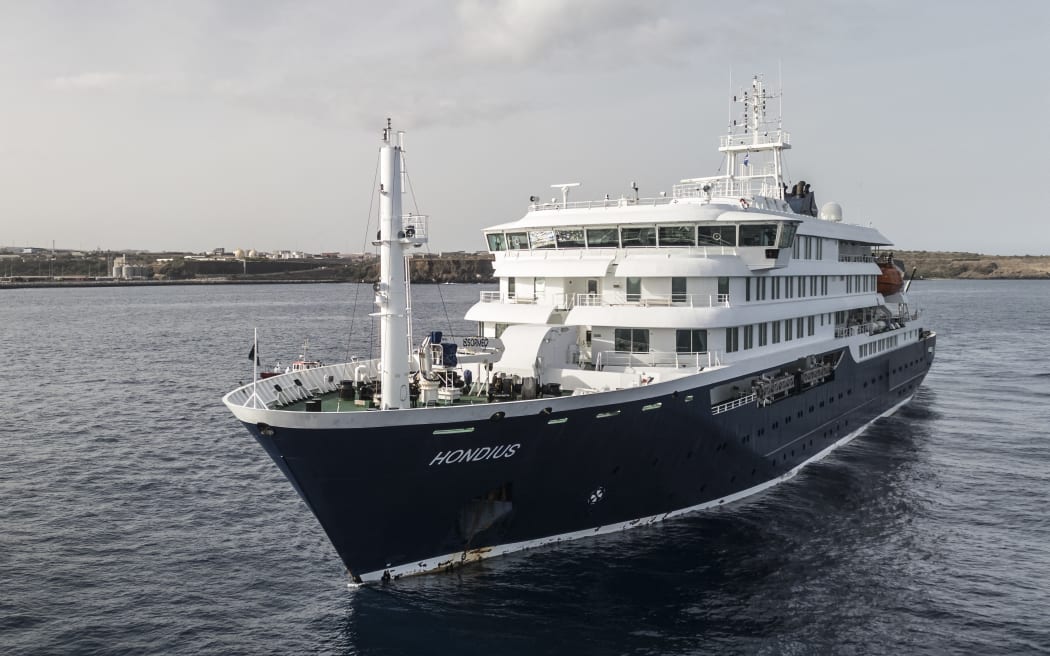 An aerial view of the cruise ship MV Hondius stationary off the port of Praia, the capital of Cape Verde, on May 5, 2026. Two seriously ill crew members on a cruise ship stricken by a deadly hantavirus outbreak will be evacuated via Cape Verde to the Netherlands, allowing the vessel to sail on to Spain's Canary Islands, the ship operator said Tuesday.
The MV Hondius has been at the centre of an international health scare since Saturday, when WHO was informed that the rare disease -- usually spread from infected rodents typically through urine, droppings and saliva -- was suspected of being behind the deaths of three of its passengers.
As others fell ill, passengers and crew have been in isolation after Cape Verde authorities barred the ship from docking, and as health authorities scrambled to find a port that would take the Hondius. (Photo by AFP)