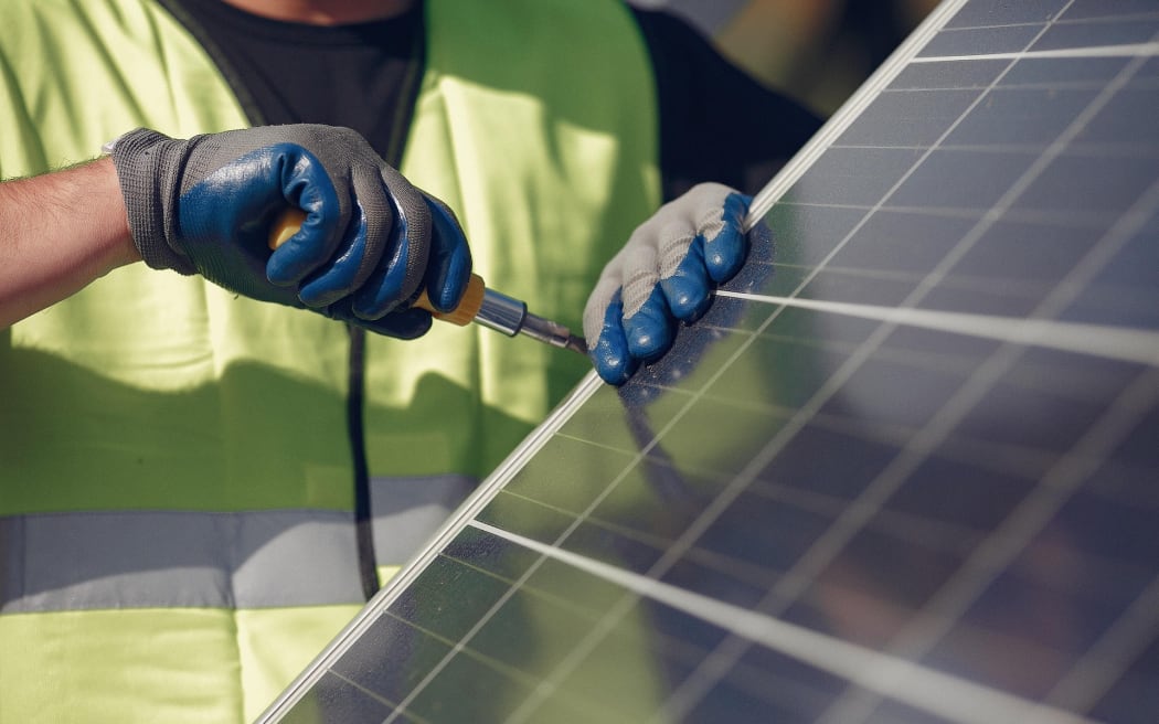 Worker and solar panels.