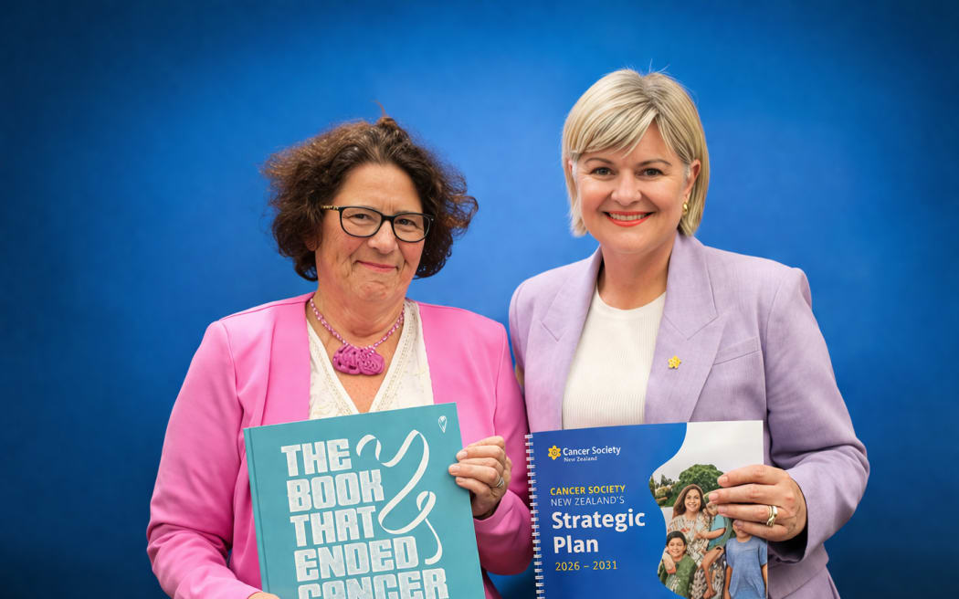 Professor Bev Lawton and Cancer Society CEO Nicola Coom holding publications about eliminating cervical cancer.