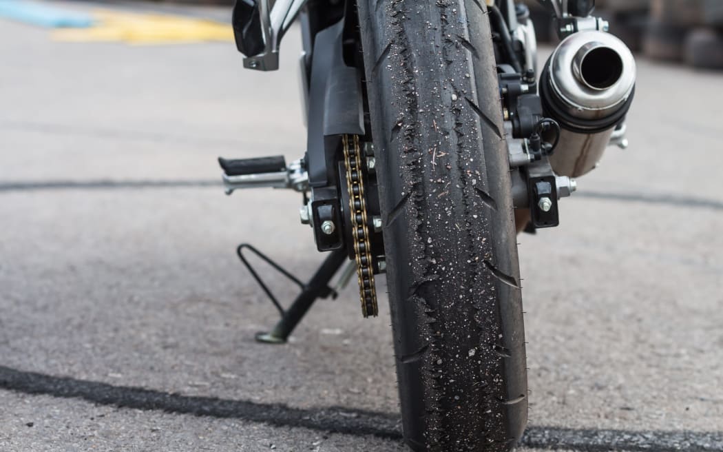 Patterned of wheel racing motorcycle on the road.