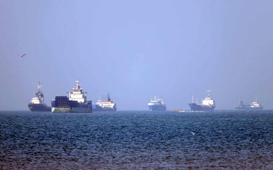 In this picture obtained from Iran's ISNA news agency on May 4, 2026, vessels are pictured anchored in the Strait of Hormuz off Bandar Abbas in southern Iran. Iran's Revolutionary Guards on May 4 denied that any commercial ships had crossed the Strait of Hormuz, after the US military earlier said two US-flagged merchant vessels had transited through the vital waterway. (Photo by Amirhossein KHORGOOEI / ISNA / AFP) /
