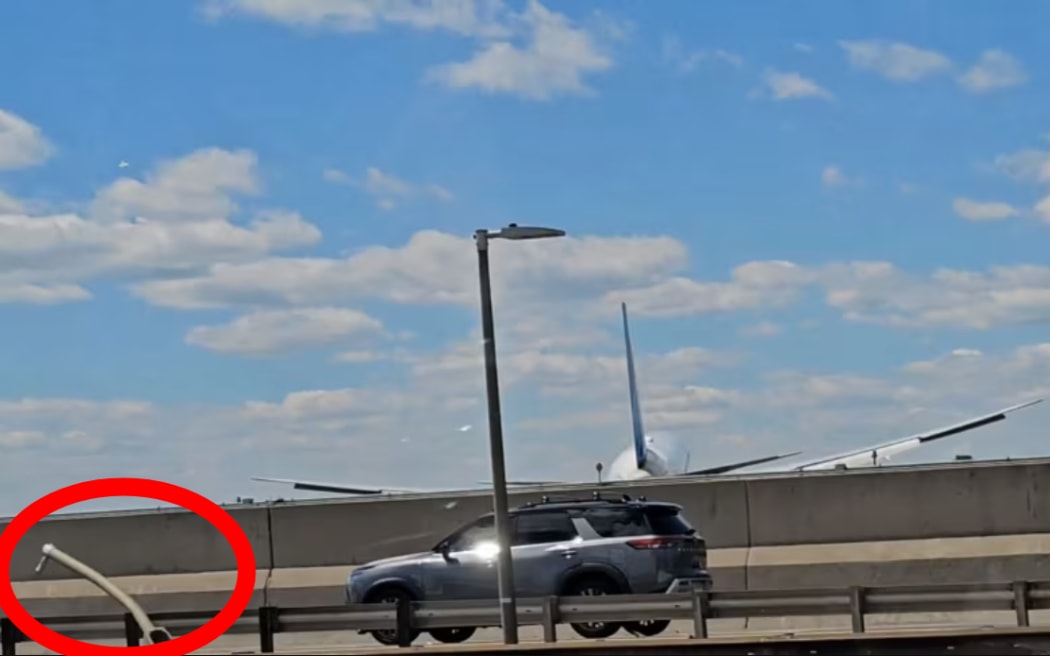 A still image taken from video shows a United Airlines Boeing 767 landing at Newark Liberty International Airport after apparently damaging a streetlight and truck.