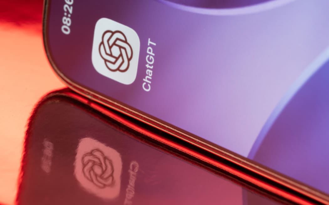 New York, USA - February 23, 2026: ChatGPT icon application on smartphone screen close up with pink reflection on pink background