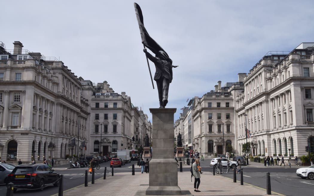 A Banksy statue depicting a man holding a flag which obscures his face appeared in Waterloo Place in Central London on April 30.