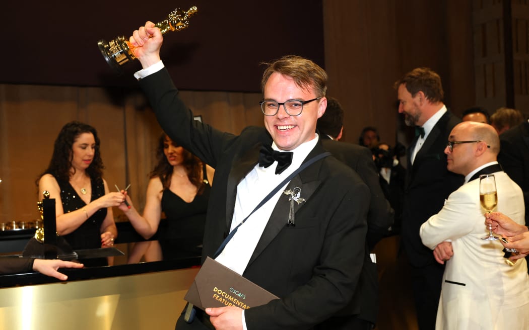 Russian teacher Pavel Talankin hoists his Oscar for Best Documentary Feature Film for