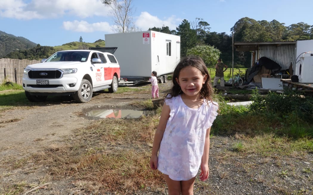 Te Aomarama, 5, waits while the family cabin is moved to higher ground.