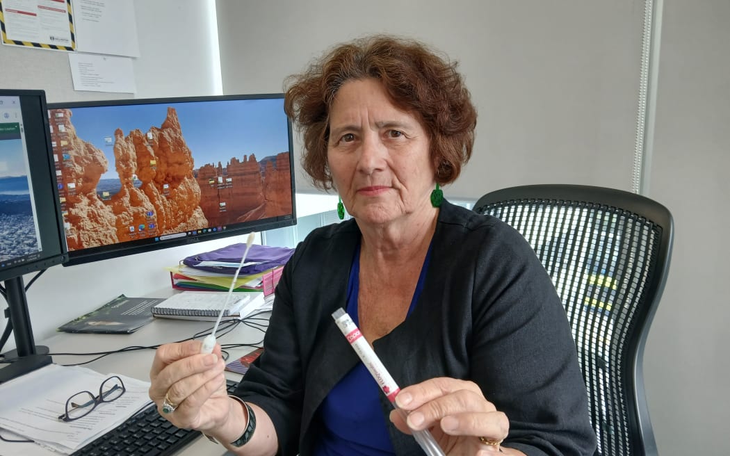 Professor Bev Lawton holding an HVP swab