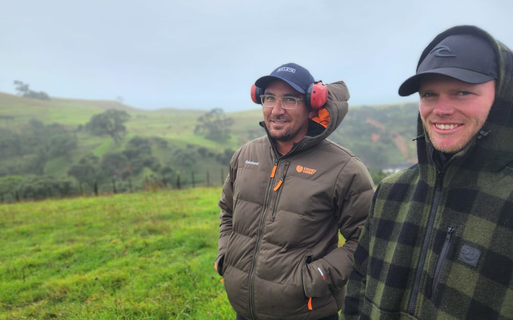Kirean Wetere and farm manager Matthew Payne standing at one of the highest points of the farm