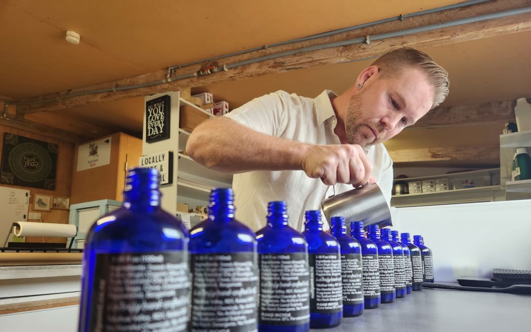 Blair blends essential oils and bottles them for his customers