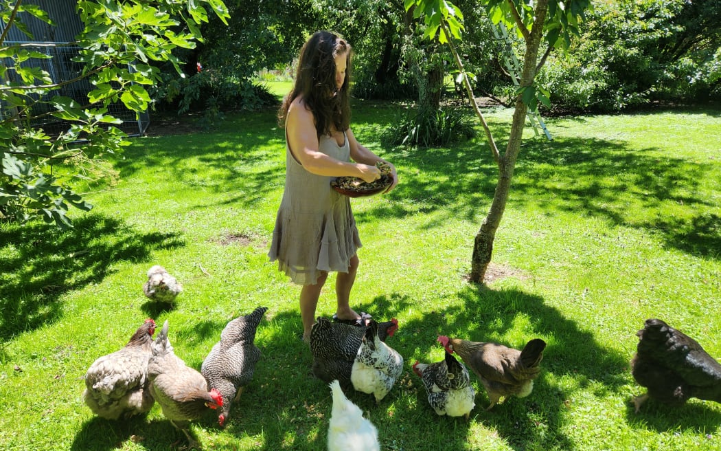 Nicole feeding the chickens