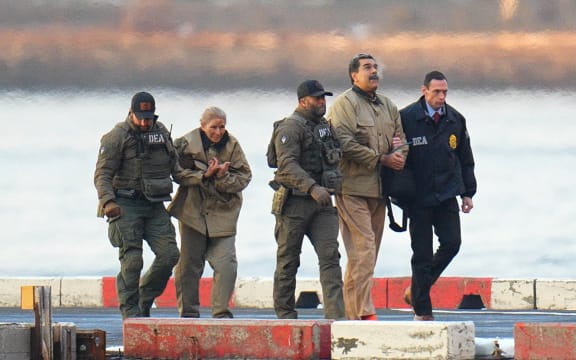 NEW YORK, NY - JANUARY 5: Nicolas Maduro and his wife, Cilia Flores, are seen in handcuffs after landing at a Manhattan helipad, escorted by heavily armed Federal agents as they make their way into an armored car en route to a Federal courthouse in Manhattan on January 5, 2026 in New York City. (Photo by XNY/Star Max/GC Images)