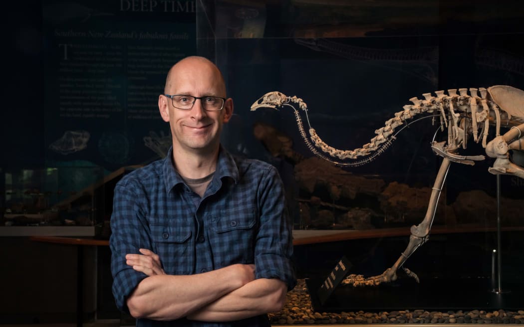 University of Otago Associate Professor Nic Rawlence and a moa skeleton.