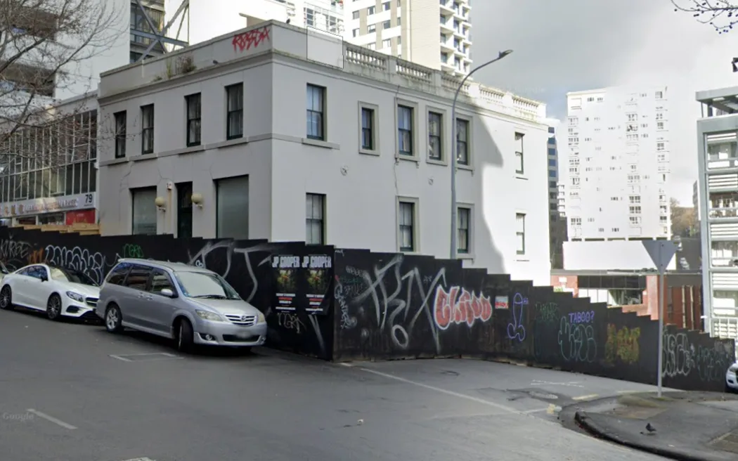 The former Fitzroy Hotel on the corner of Wakefield and Lyndock streets in Auckland CBD in July 2024. Half of Lyndock Street was boarded up but recently workers came back and totally blocked off Lyndock Street with hoardings.