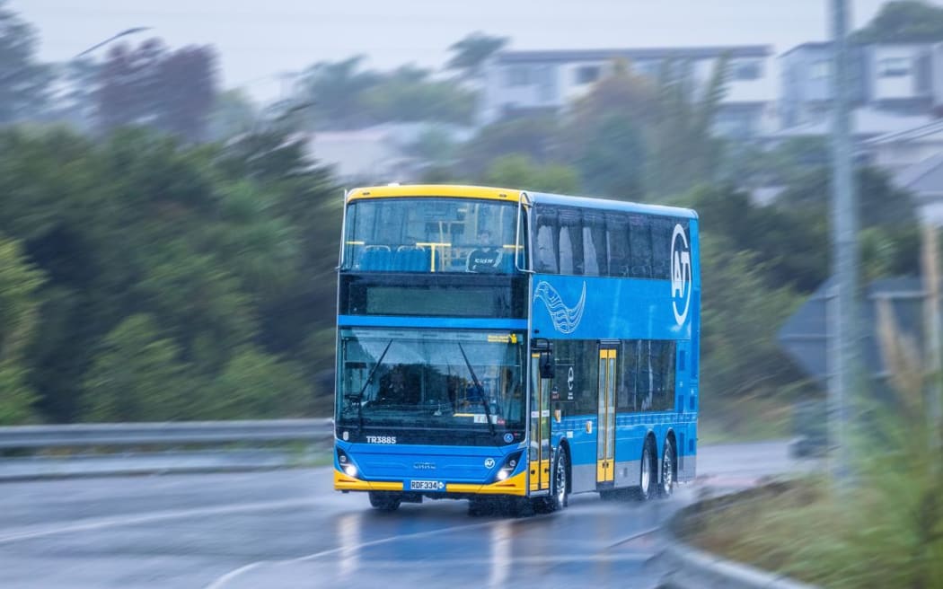 An electric double-decker bus in rainy Auckland conditions.