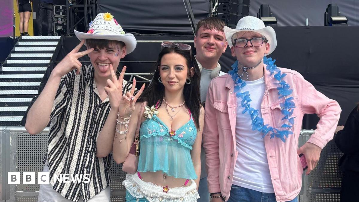 From left, Lennon, Jess, Ryan and Sam smile into the camera as they stand in front of one of the event's stages. They are dressed up with two of the boys wearing cowboy hats.