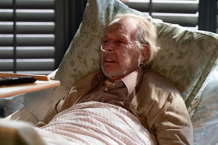 559309,TITLE:Eastenders Eddie lies in a hospital bed in Nicola's living room in EastEnders