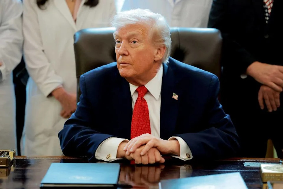donald trump sitting at desk