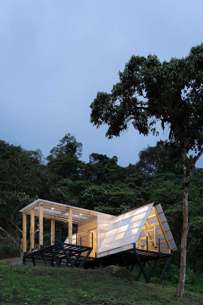 translucent polycarbonate skin envelopes triangular shelter elevated on stilts in ecuador - 9