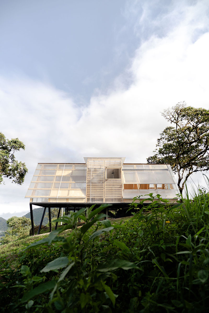 translucent polycarbonate skin envelopes triangular shelter elevated on stilts in ecuador - 4
