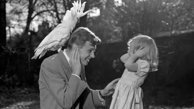 File photo dated 07/12/57 of three year old Susan and her father David Attenborough covering their ears as sulphur-crested cockatoo Georgie lets out a piercing shriek.