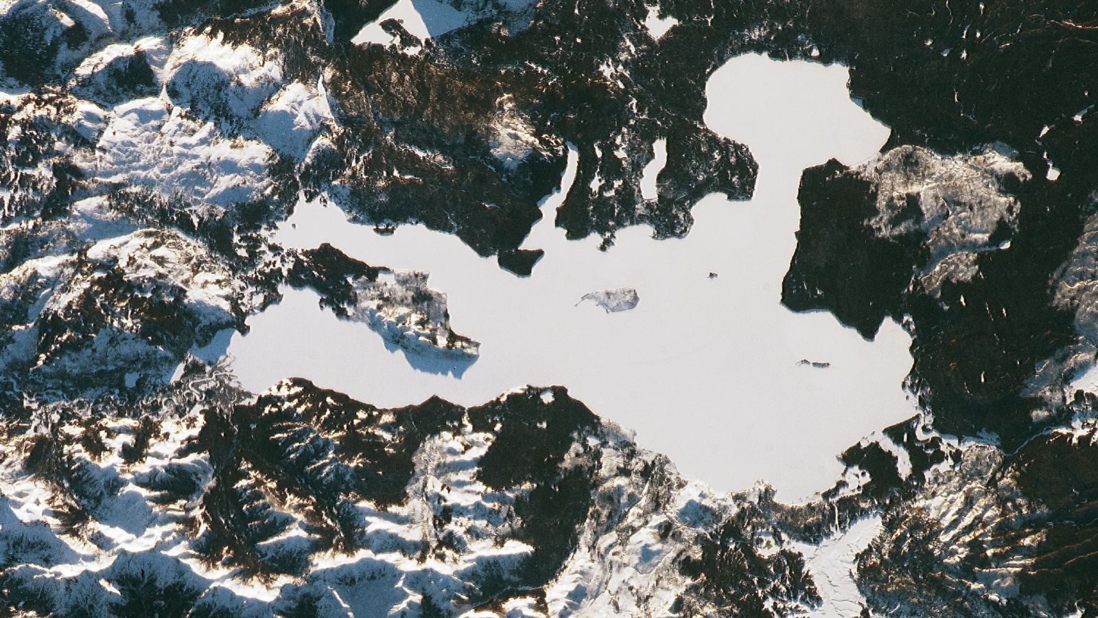 An astronaut photo of a perfectly white lake in Yellowstone National Park