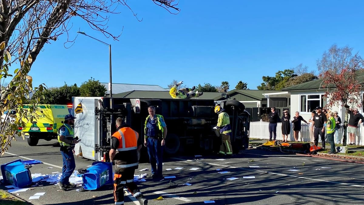 Truck rolls, scattering paper debris over Hastings street