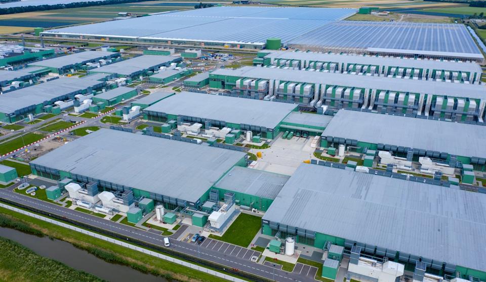 A massive AI data center sits expands across the horizon. 