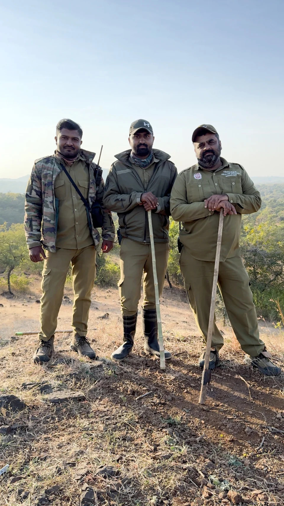Park trackers (Sohil Makwana, Kirit Vikama, and Sagar Manjaria, from left to right) join Steve Winter and writer Sharon Guynup in the field.