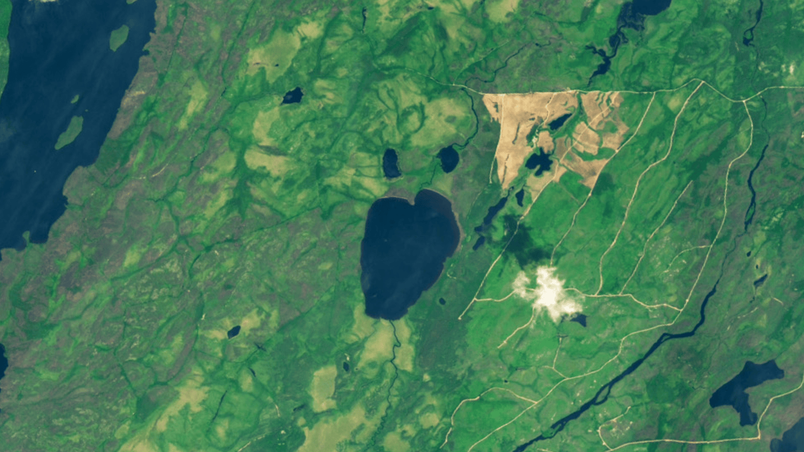 Looped satellite photos showing before and after a face-shaped Canadian lake completely emptied
