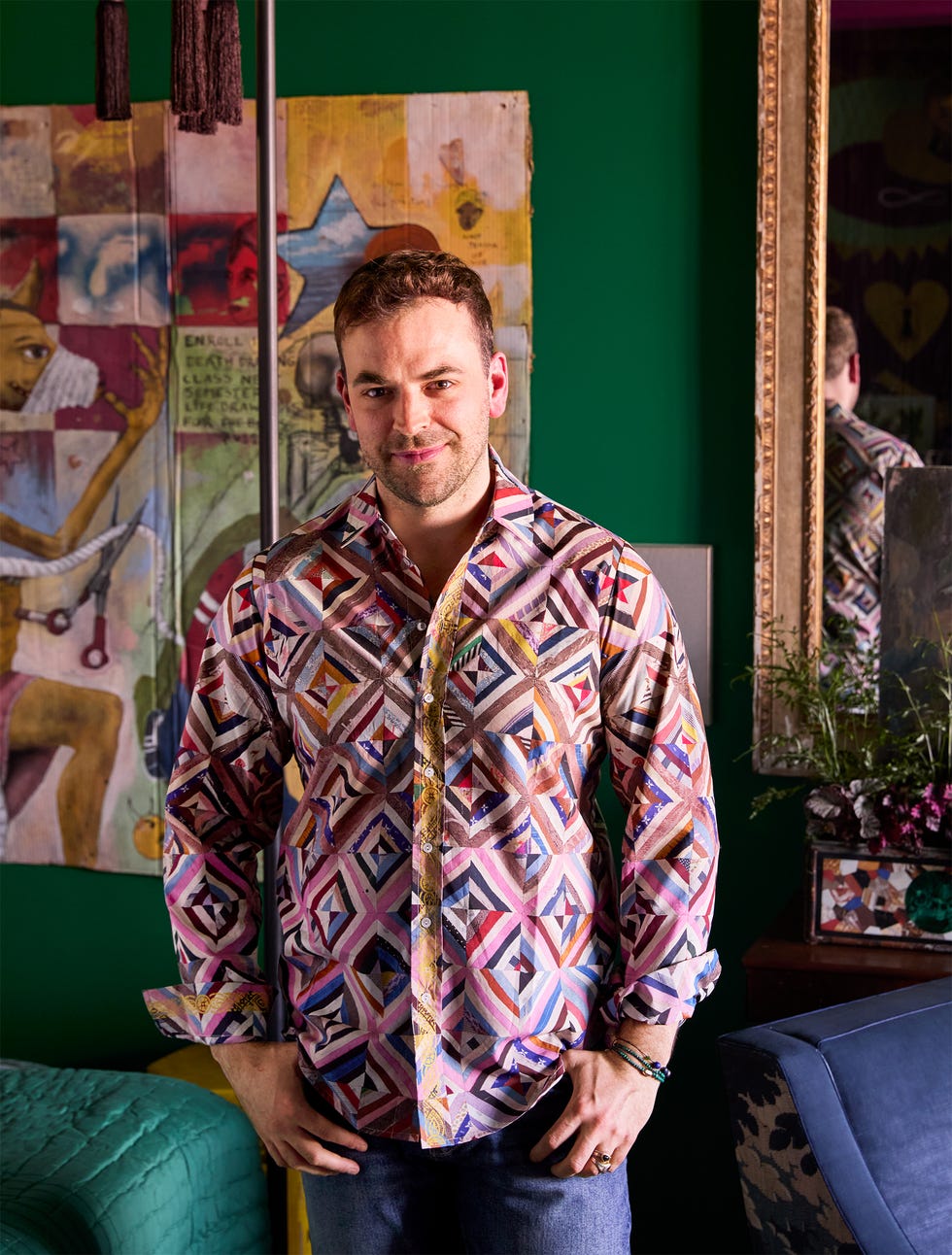 A person wearing a colorful patterned shirt in a stylish interior.