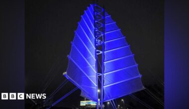 Portsmouth’s Sails of the South sculpture lit up in blue lights.