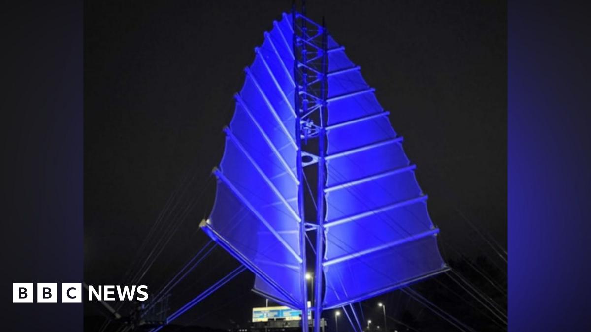 Portsmouth’s Sails of the South sculpture lit up in blue lights.