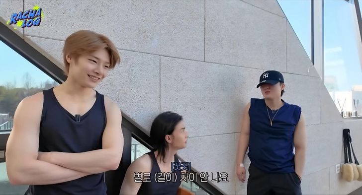 Stray Kids' members take a break during a Pilates challenge. Captured from YouTube