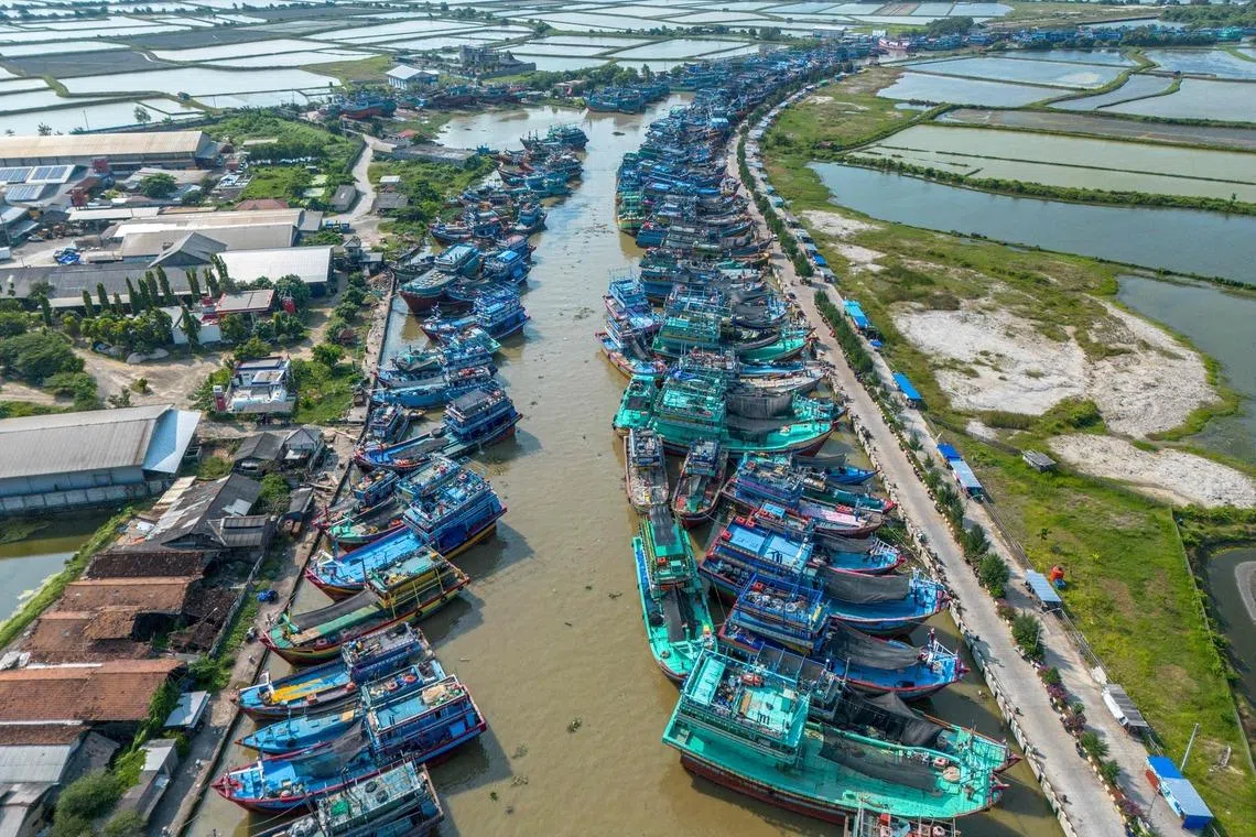 Fshing boats docked ashore at a port in Juwana, Central Java on May 6.