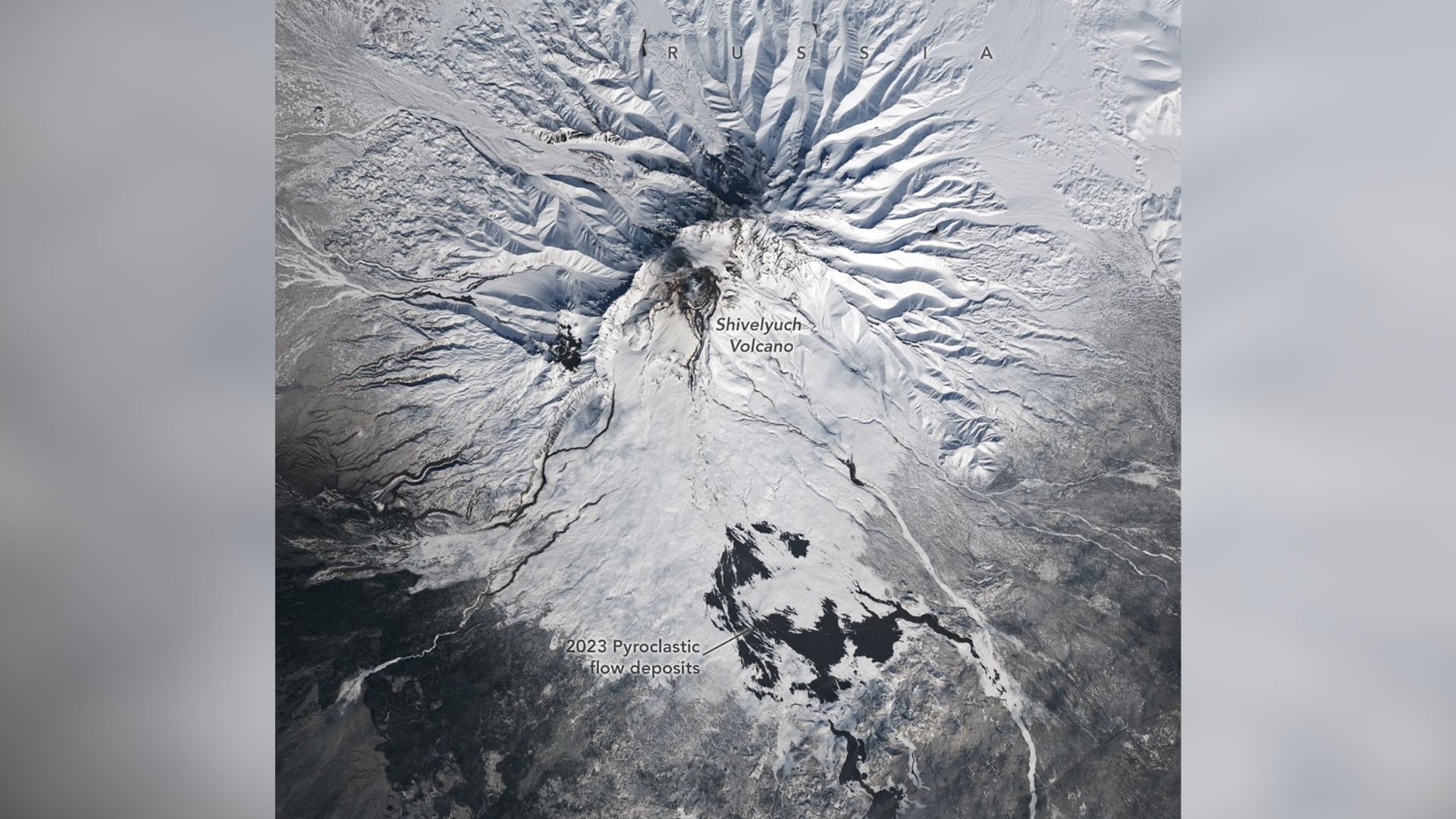 snowy volcano with dark scars on the landscape