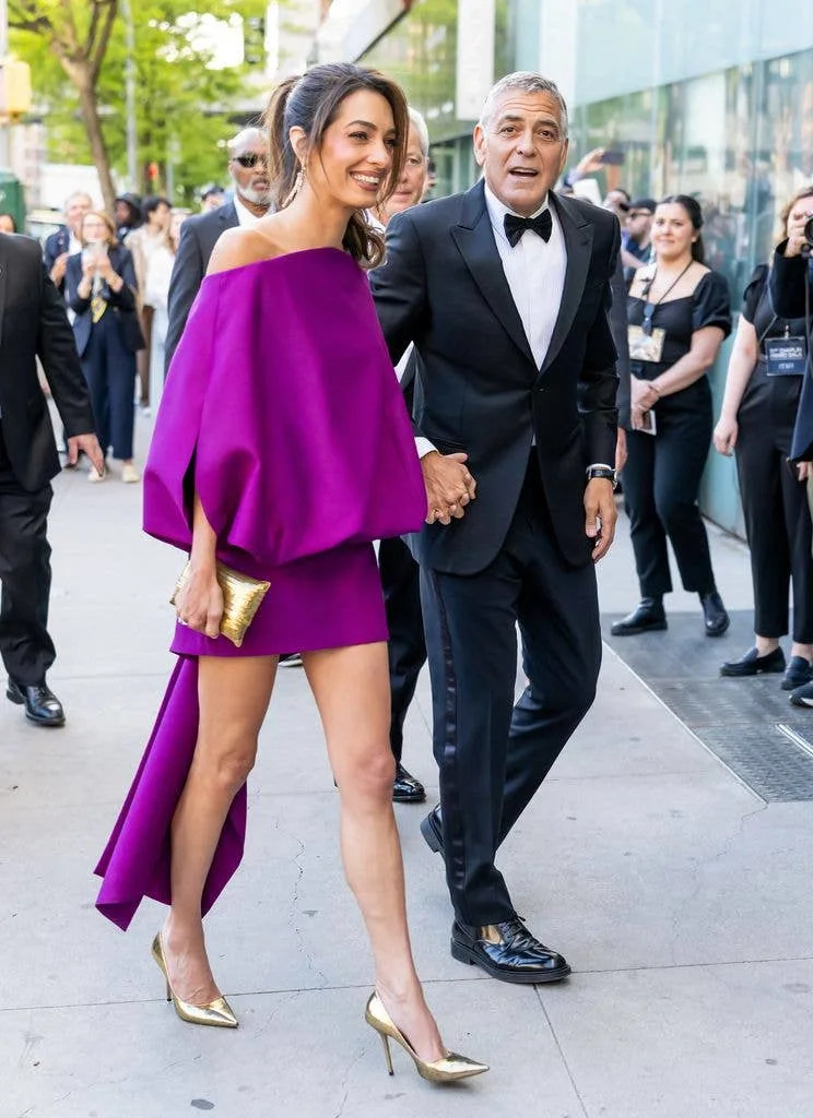 Amal in magenta mini dress walking with george in suit