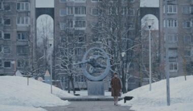 a woman walking through a snowy city scene