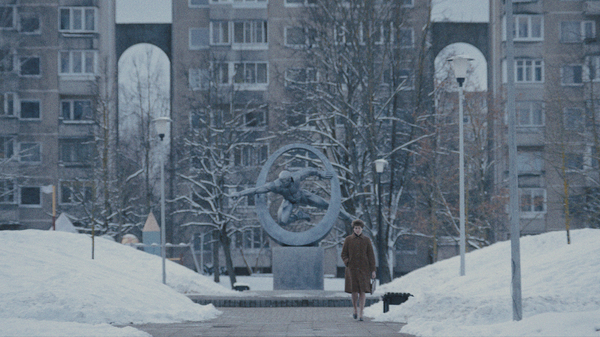 a woman walking through a snowy city scene
