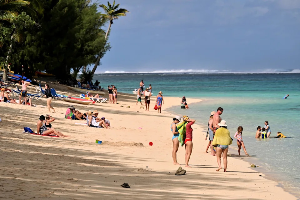 Tourists relax at a resort on Rarotonga, the largest island of the Cook Islands on June 12, 2025. (Photo by William WEST / AFP) (Photo by WILLIAM WEST/AFP via Getty Images)