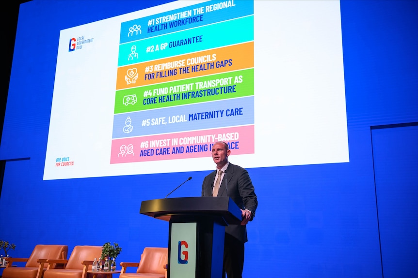 A man gives a presentation on stage