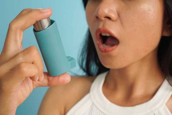 Asthma Treatment Concept: Close-Up of a Woman Holding an Inhaler Asthma Treatment Concept: Close-Up of a Woman Holding an Inhaler